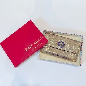 Kate Spade gold party clutch with removable strap. Sold in box